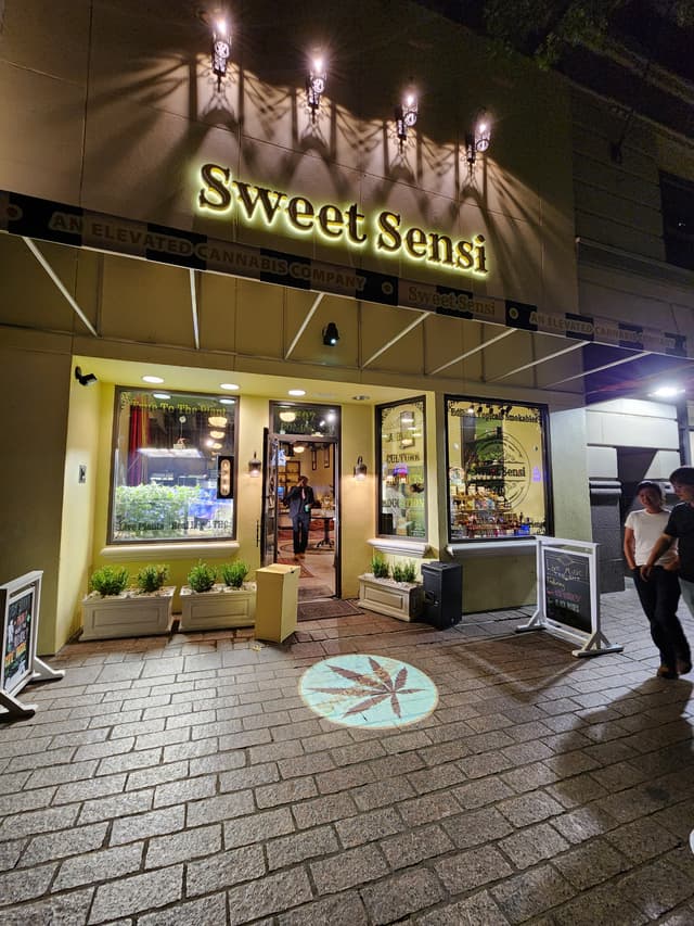 Sweet Sensi storefront at night